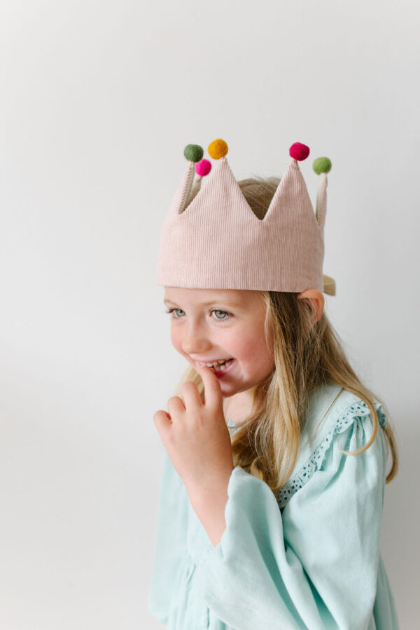 girl in pink dressing up crown