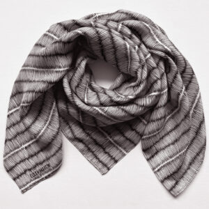 Large square silk scarf with intricate repeat pattern in black and off-white.