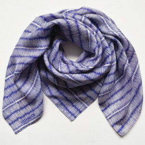 Large square silk scarf with intricate repeat pattern in blue and off-white.