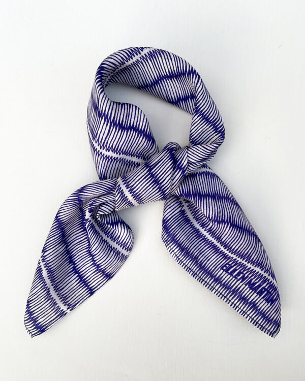 Small square silk scarf with intricate repeat pattern in blue and off-white.