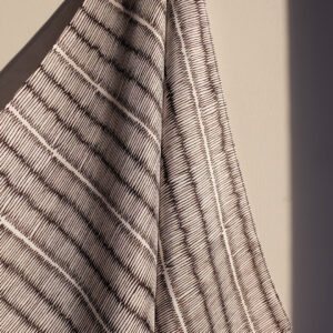 Small square silk scarf with intricate repeat pattern in black and off-white.